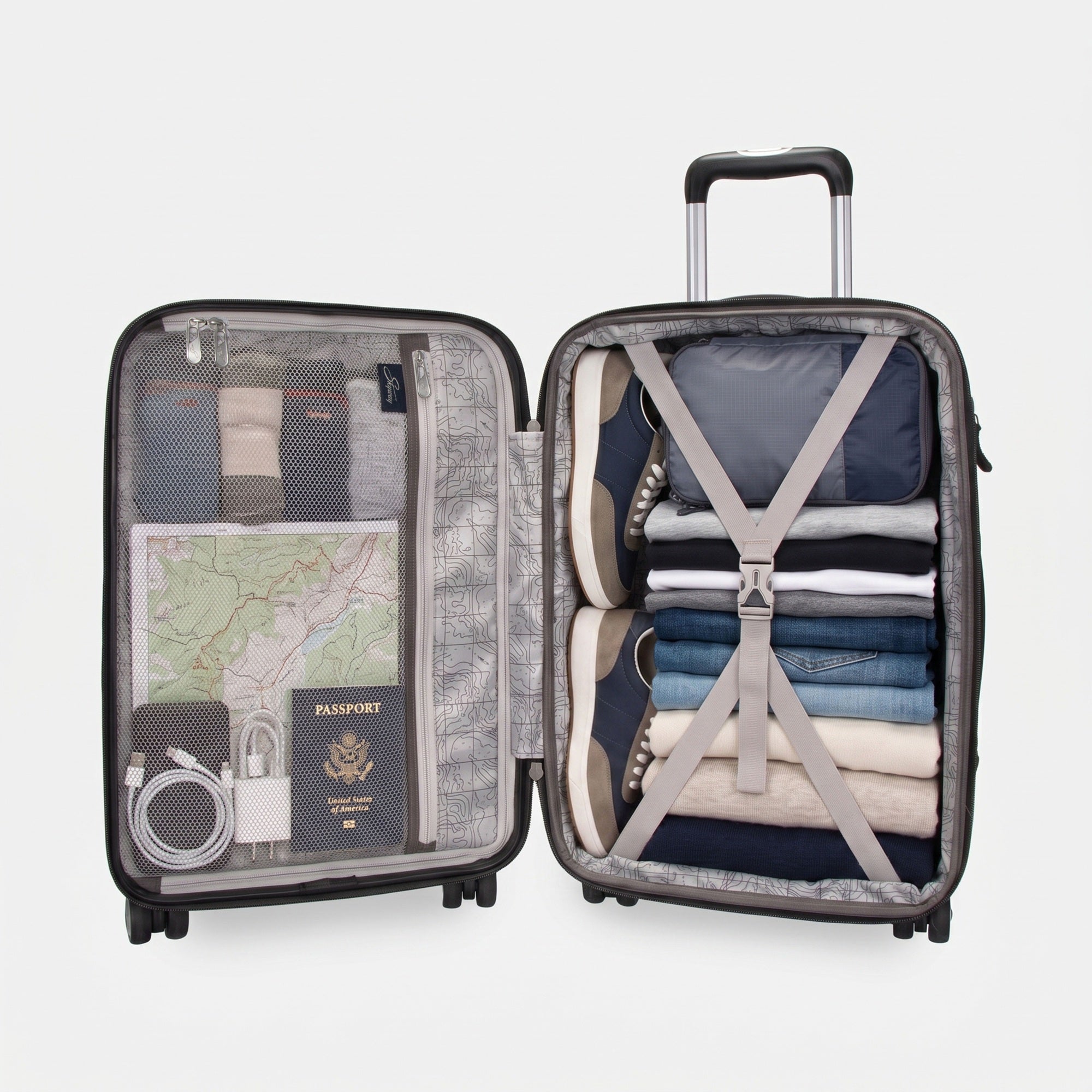 Open Nimbus 5.0 suitcase showing packed interior organization, with a zip-mesh divider holding travel documents and cables on one side, and folded clothing and shoes secured under cross-strap compression on the other.